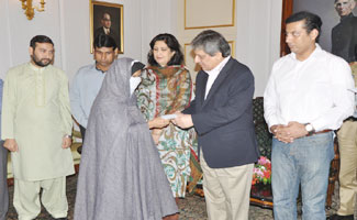 Governor distributes cheques among deserving people