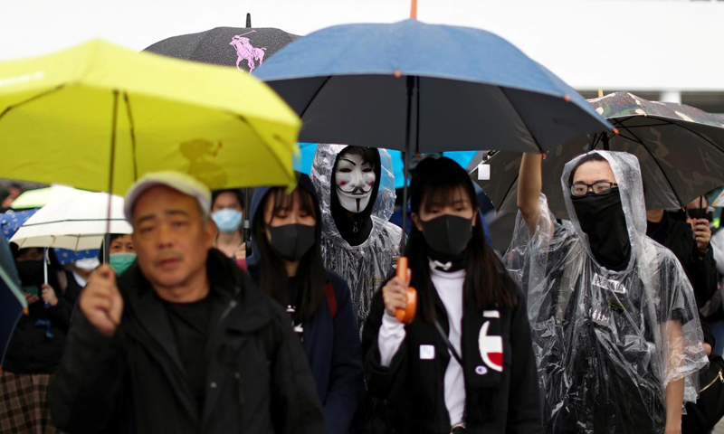 More than 1,000 gather for rain-soaked Hong Kong rally