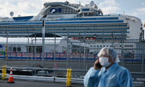 China sees drop in new virus cases, two Japan cruise passengers die