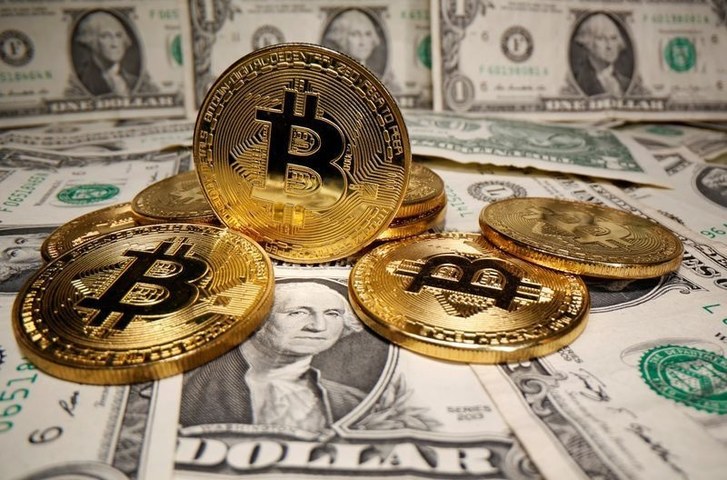 Dollar buoyed by U.S. recovery hopes, bitcoin near record $52,640