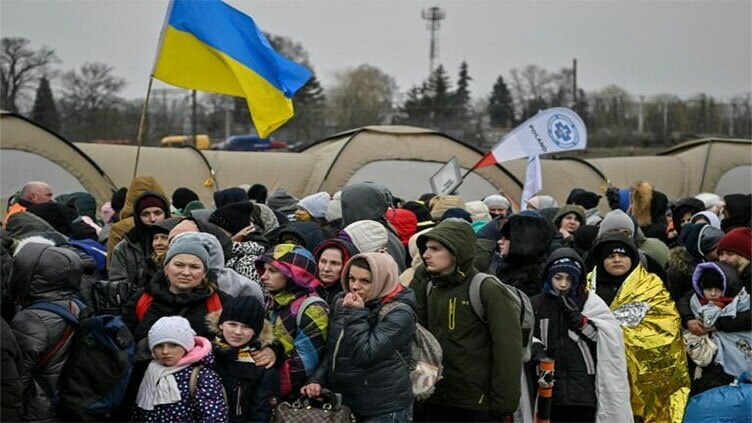 Ukrainians flee some besieged areas through 'humanitarian corridors'