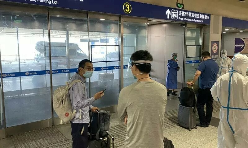 China halves quarantine time for overseas travellers