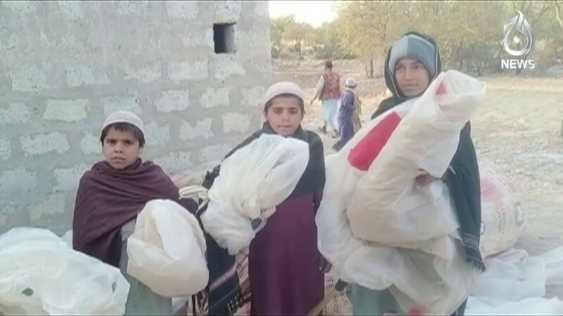    Boys wait for their turn to fill their bags with gas. Screengrab