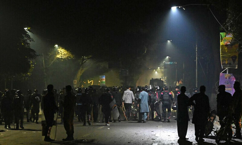 Supporters of former Pakistan prime minister Imran Khan gather along a street during a clash with police near Khan’s residence, in Lahore on March 15, 2023. - Supporters of Khan clashed repeatedly with police overnight as he remained holed up in his Lahore residence early on March 15, defying attempts to arrest him – AFP