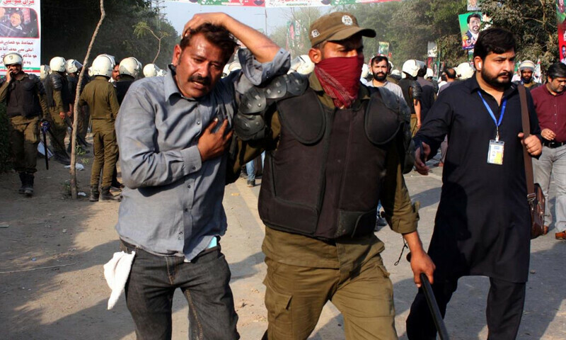 Police officials restore baton charge, fire tear gas and arrest to repel supporters of Tehreek-e-Insaf (PTI) to arrest former prime minister Imran Khan in the Toshakana case, outside Zaman Park in Lahore on Tuesday, March 14, 2023. Law enforcers and Pakistan Tehreek-e-Insaf (PTI) workers clashed Tuesday as a heavy contingent of police reached Zaman Park to arrest former prime minister Imran Khan in the Toshakana case, the only case in which his arrest warrants are not suspended – PPI