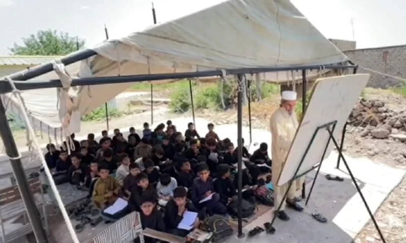 Think its too hot? Bara pupils study under tents, hollowed-out buildings