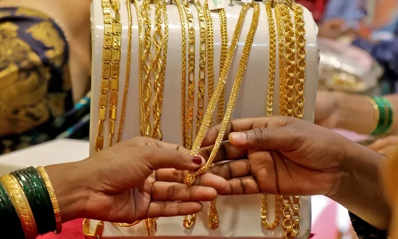 Gold gains on softer dollar as markets await more Fed cues