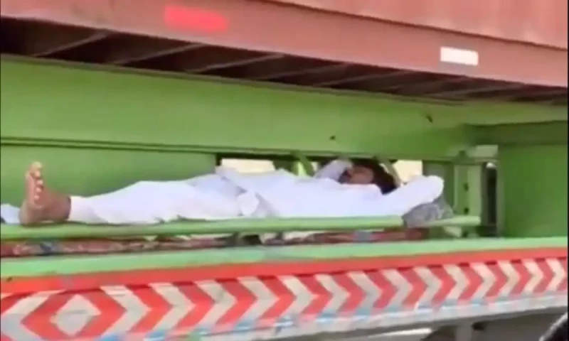 Social media claims man sleeping on moving truck is Pakistani