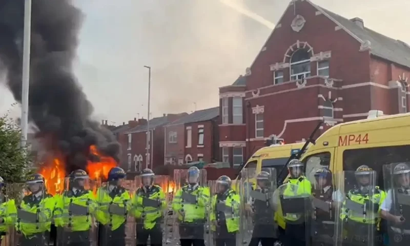 Protesters attack mosque, clash with police in England