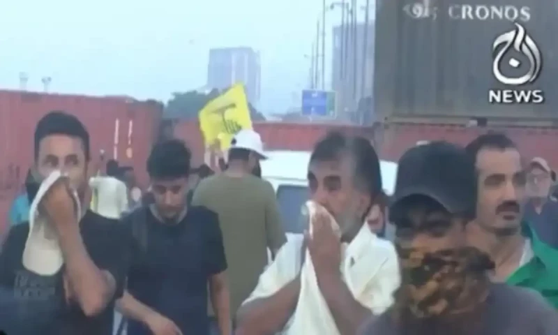 Police fire tear gas to stop protesters from marching towards US consulate in Karachi