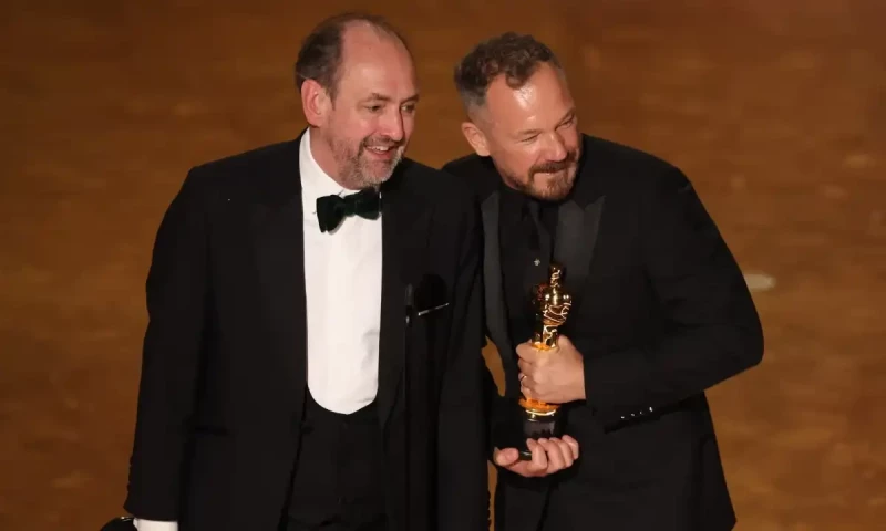 Nathan Crowley and Lee Sandales accept the Oscar for best production design for Wicked. Reuters
