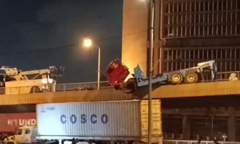 Speeding trailer hangs off bridge in Karachi after crash