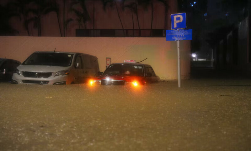 Vehicles are partially submerged during heavy rains in Hong Kong, China, on Tuesday. – Reuters