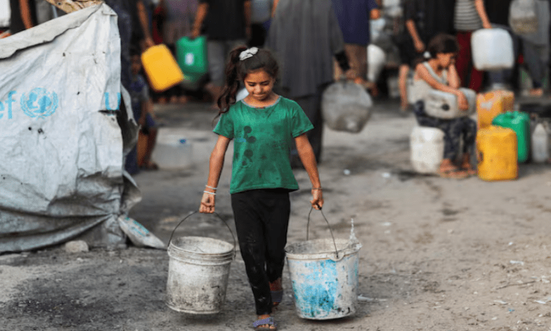 A Palestinian girl carries buckets of water amid shortages, in Gaza City on August 6, 2025. Reuters