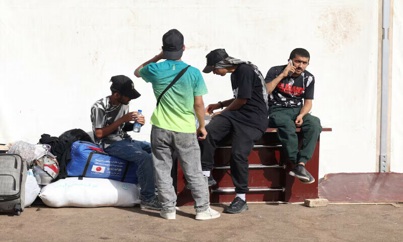 Afghan nationals, who were deported from Iran, rest with their belongings at a camp set up for returning migrants near the Islam Qala border crossing in Herat province, Afghanistan. – Reuters