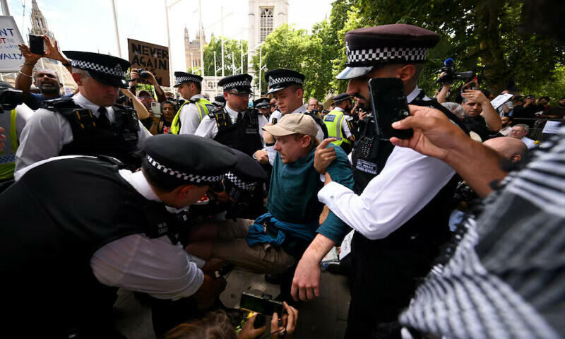 Police officers detain a demonstrator during a rally organised by Defend Our Juries, challenging the British government’s proscription of “Palestine Action” under anti-terrorism laws, in Parliament Square, in London, Britain. – Reuters