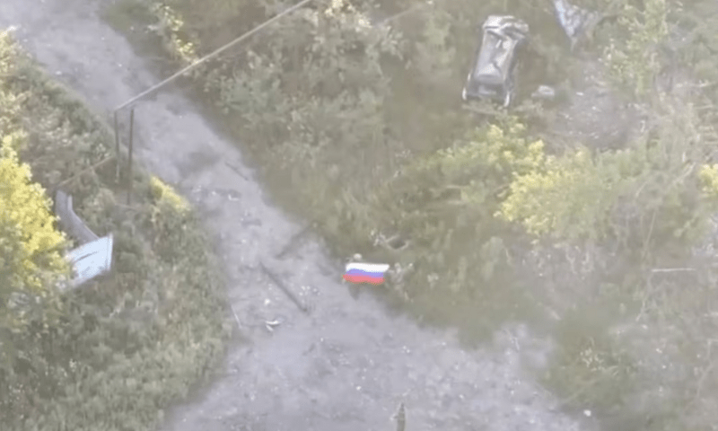 A still image, taken from footage released by the Russian Defence Ministry, shows what it said to be Russian soldiers waving a flag following the capture of Ukraine’s Yablunivka (Yablonovka) settlement in the Donetsk region in the course of Russia-Ukraine military conflict, in this image from video released on August 12, 2025. Reuters