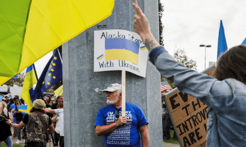 A demonstrator holds a placard during a protest in solidarity with Ukraine, ahead of the meeting in Anchorage, Alaska, on August 14, 2025. Reuters