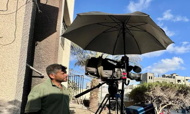 Palestinian cameraman Hussam Al Masri, who was a contractor for Reuters and killed in Israeli strikes on Nasser hospital, stands next to his camera in this undated picture. – Reuters
