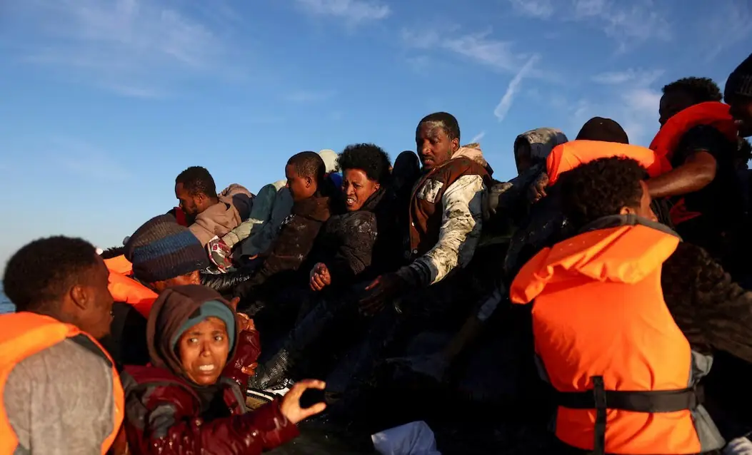 A group of migrants board an inflatable dinghy before leaving the coast of northern France in an attempt to cross the English Channel to reach Britain, from the beach of Petit-Fort-Philippe in Gravelines, near Calais, France, August 25, 2025. REUTERS