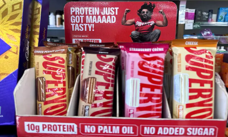 Superyou co-founder Ranveer Singh’s advertisement is displayed next to Superyou protein wafer bars at a medical store in Mumbai, India. – Reuters