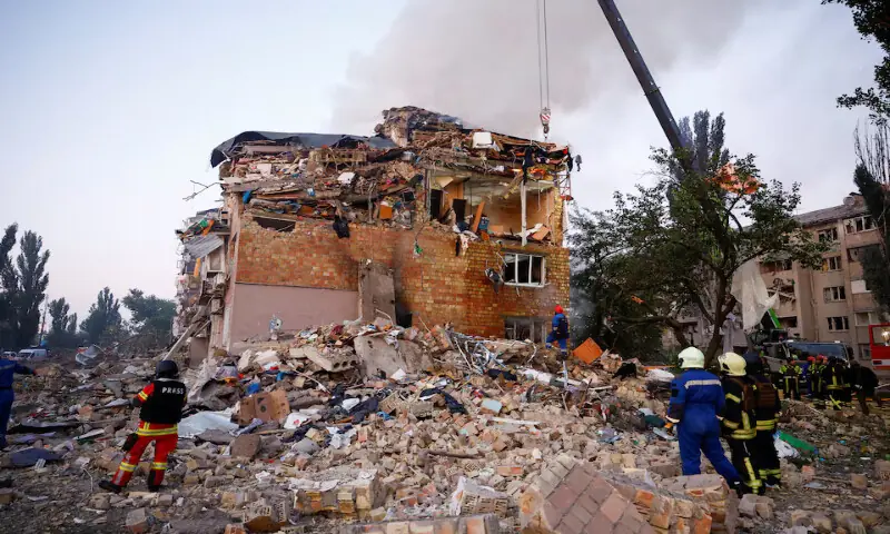 Rescuers work at the site of a building which was hit by a Russian missile and drone strike in Kyiv, Ukraine, on Thursday. – Reuters