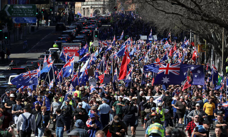 Demonstrators carry Australian flags during the ‘March for Australia’ anti-immigration rally, in Sydney, Australia, on Sunday. – Reuters