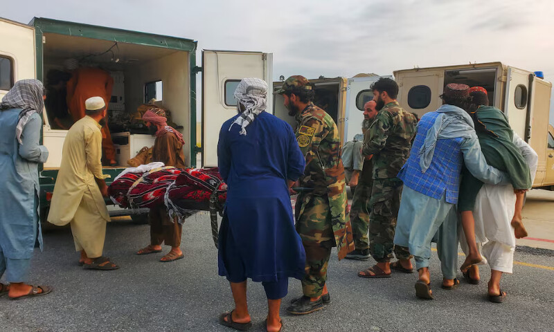Taliban soldiers and civilians carry earthquake victims to an ambulance at an airport in Jalalabad, Afghanistan, on Monday. – Reuters