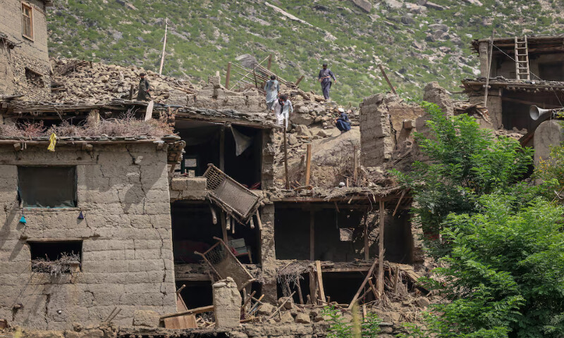Afghan men stand on top of a damaged house following the deadly earthquake in Mazar Dara, Kunar province, Afghanistan. – Reuters
