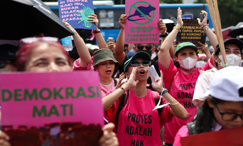 Women shout slogans during a protest against lawmakers’ perks and police brutality outside the Indonesian parliament building in Jakarta on Wednesday. – Reuters