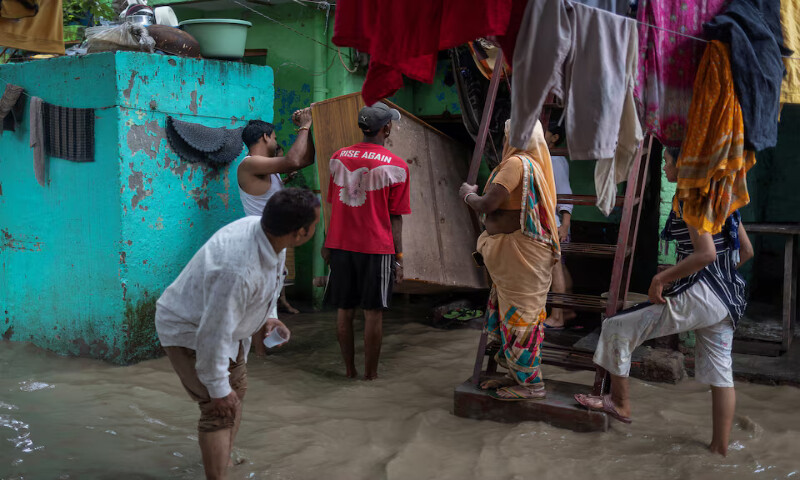 People shift their beds to a safer place after a rise in the water level of the river Yamuna in New Delhi, India. – Reuters