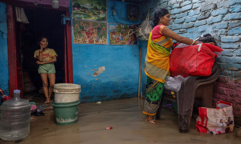 Munni Devi and her daughter gather their belongings before evacuating their house in New Delhi, India. – Reuters