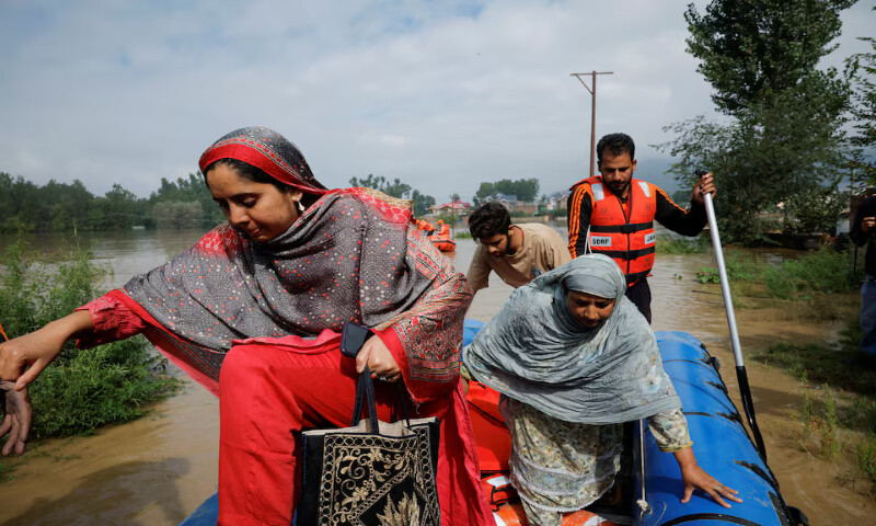 Members of the National Disaster Response Force evacuate a family from their home due to the rising water levels in the Jhelum River bund at Zoonipora village in Indian-occupied Kashmir’s Budgam district on Thursday. – Reuters