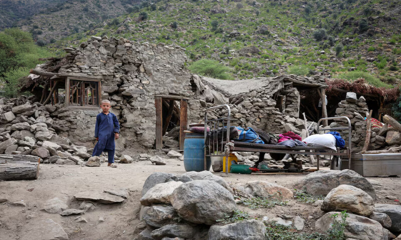 A boy stands in front of a house after the deadly earthquake at Lulam village, in Nurgal district, Kunar province, Afghanistan. – Reuters