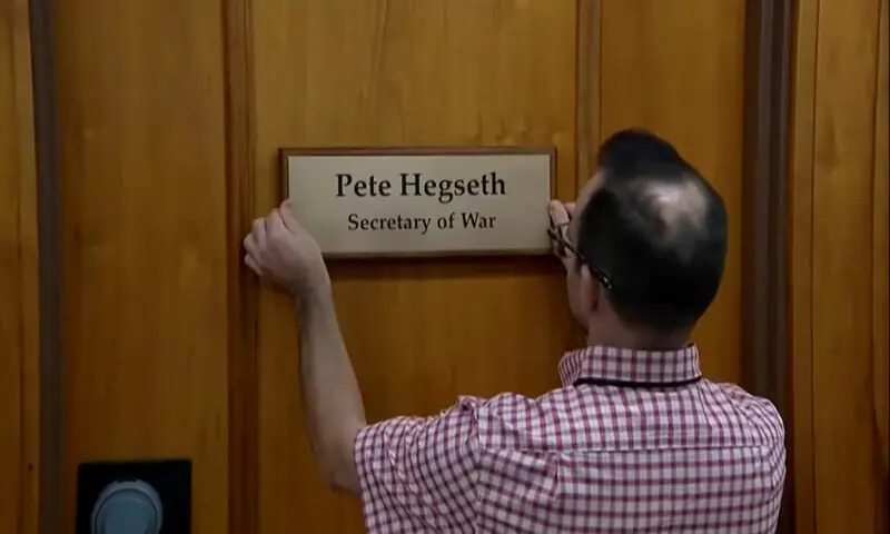 A worker places a plaque that reads “Pete Hegseth - Secretary of War” after US President Donald Trump signed an executive order to rename the Department of Defence as the “Department of War” in Washington, DC. – Reuters