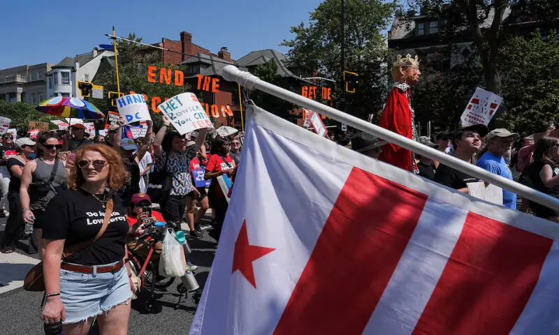 Demonstrators attend the “We Are All DC” march to protest against National Guard troops’ deployment in Washington, DC. – Reuters