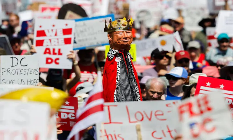 A demonstrator holds a representation of US President Donald Trump wearing a crown, during the “We Are All DC” march to protest against the National Guard troops, in Washington, DC. – Reuters