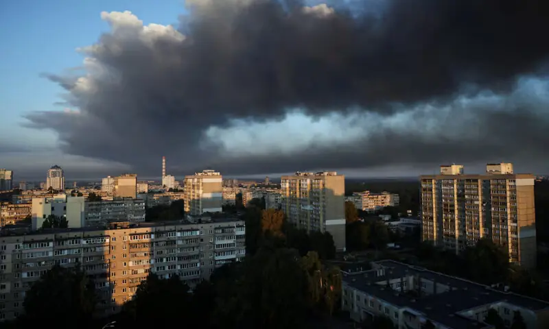 Thick smoke from a nearby strike site fills the sky during a Russian drone strike in Kyiv, Ukraine, on Sunday. – Reuters