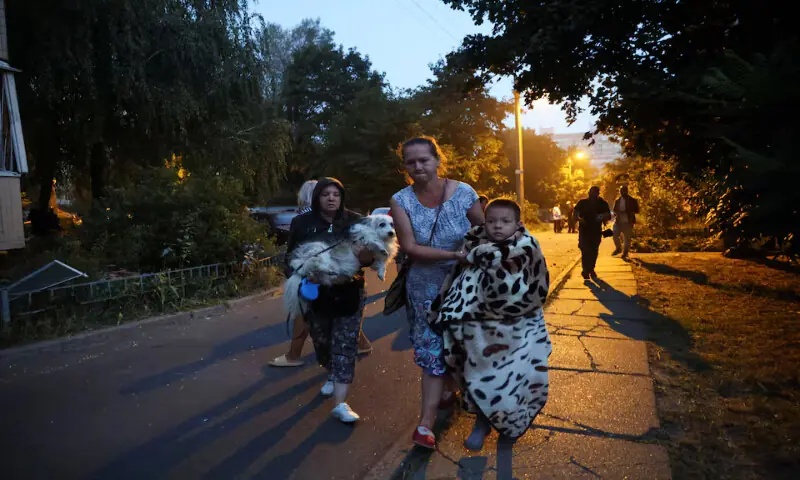 Residents move towards a shelter from their apartment building that was damaged during a Russian drone strike in Kyiv, Ukraine, on Sunday. – Reuters