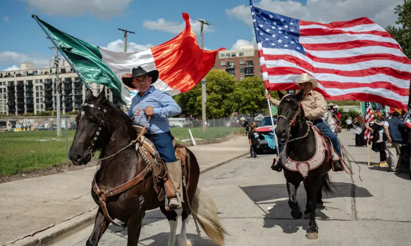 Parade participants on horseback fly the Mexican and American flags as Chicago’s Mexican community proceeds with a Mexican Independence Day parade after US President Donald Trump ordered increased federal law enforcement presence, in Chicago, Illinois. – Reuters