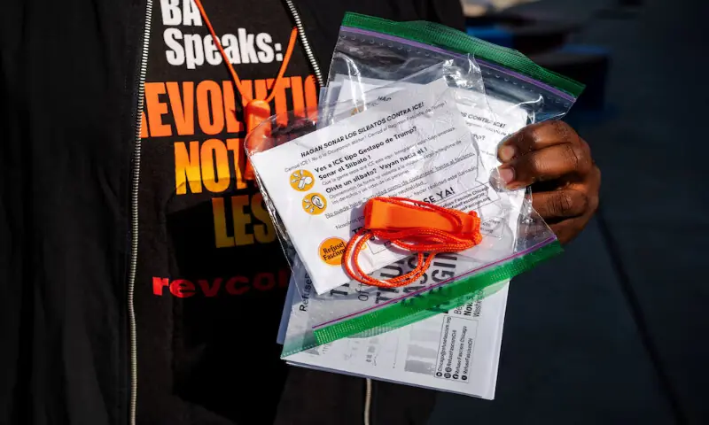 A community watch member holds a whistle kit used to alert other community members of the presence of ICE agents in the area as Chicago’s Mexican community proceeds with a Mexican Independence Day parade after US President Donald Trump ordered increased federal law enforcement presence, in Chicago, Illinois. – Reuters