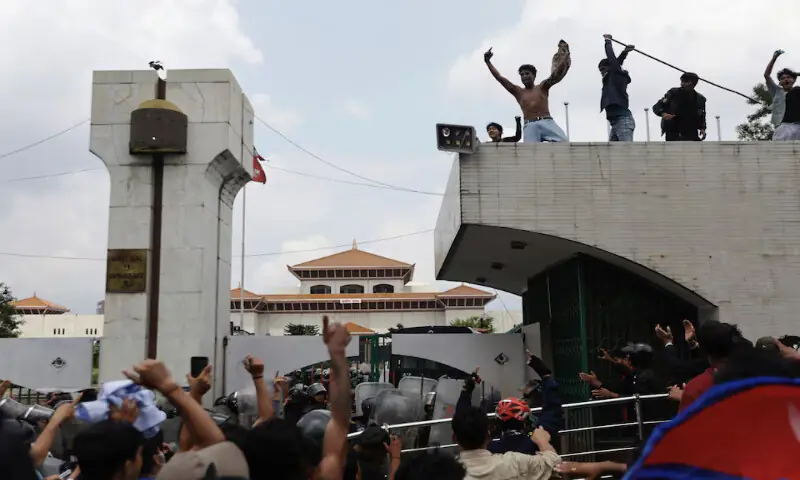 Demonstrators shout slogans as they stand atop the entrance of the Parliament during a protest against corruption and the government’s decision to block several social media platforms, in Kathmandu, Nepal, on Monday. – Reuters