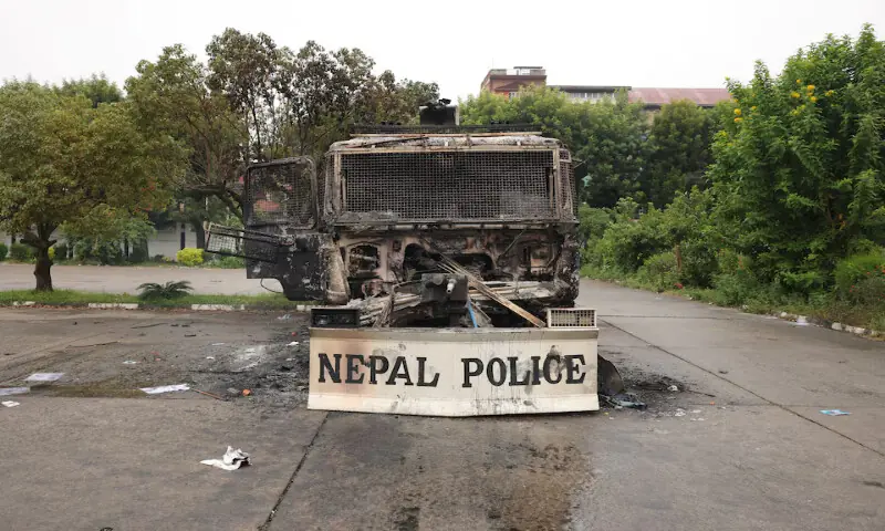 Charred remains of a Nepal Police vehicle sit inside the Parliament house, which was set on fire by protesters in Kathmandu, Nepal, on Wednesday. – Reuters