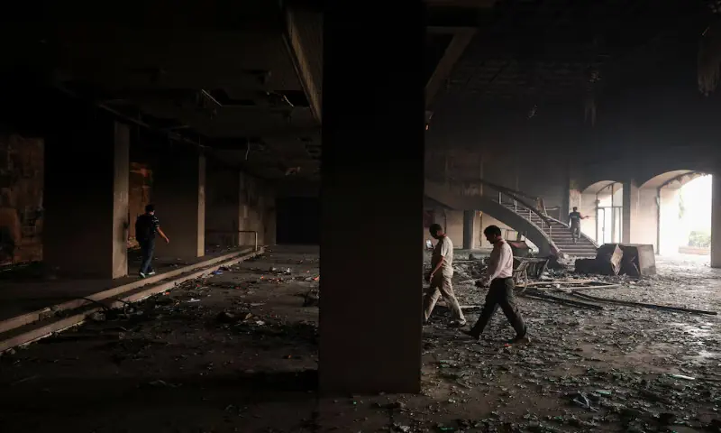Members of the media walk inside the Parliament house, which was set on fire by protesters in Kathmandu, Nepal, on Wednesday. – Reuters