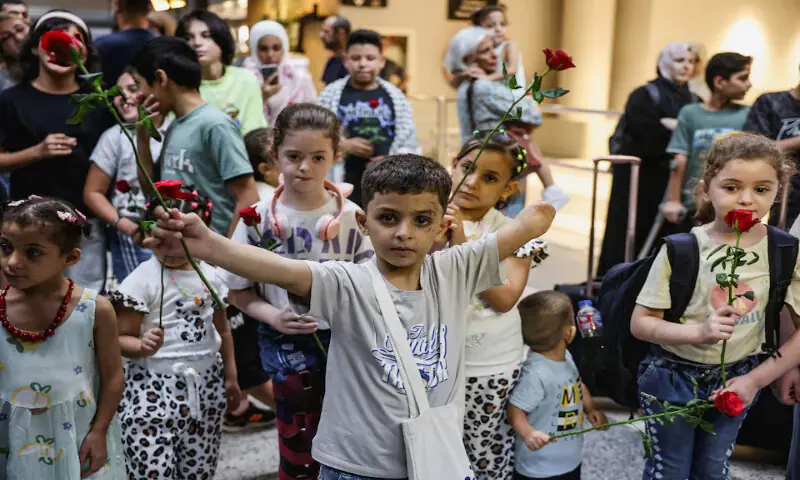 A child who lost an arm during an Israeli attack, holds up a flower as six Gazan families with wounded children arrive at Beirut-Rafic Hariri International Airport for medical treatment in Beirut, Lebanon. – Reuters