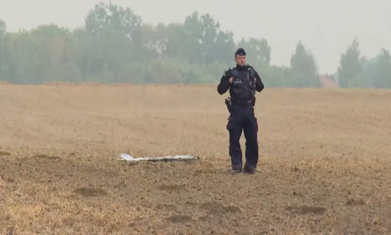 A Polish police officer stands near an unmanned aerial vehicle (UAV) fragment, after Russian drones violated Polish airspace during an attack on Ukraine, and some were shot down by Poland. Reuters
