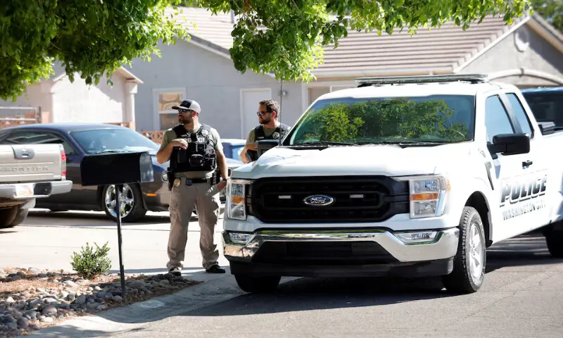 Police stand outside a residence in Washington, Utah, associated with Tyler Robinson. – Reuters
