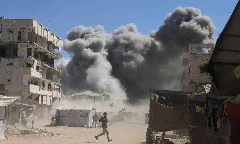 Smoke rises from a residential building after it was hit by an Israeli air strike in Gaza City on Sunday. – Reuters