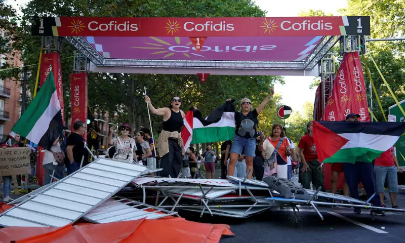Barriers are smashed during a protest against an Israeli team’s participation in the Vuelta a Espana cycle race in Madrid. – Reuters