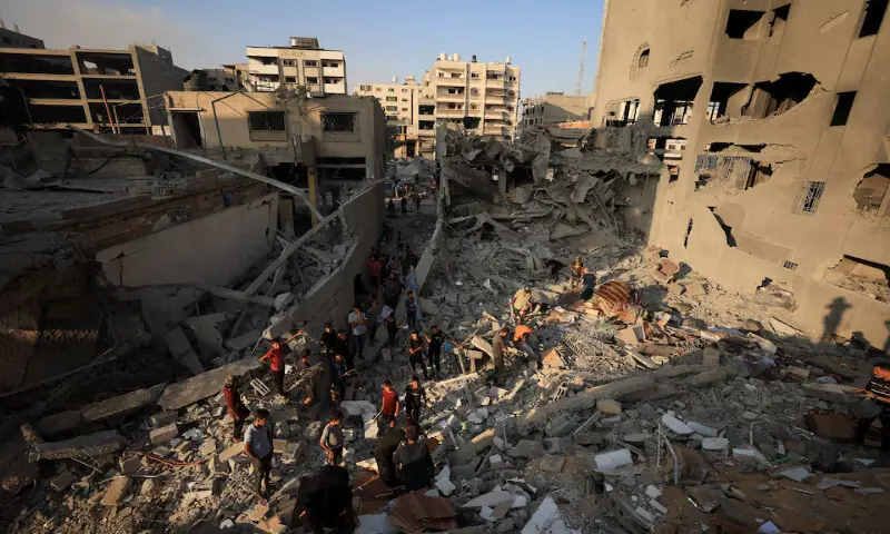 Palestinians inspect the damage at the site of Israeli strikes that destroyed Al Jundi Al Majhoul residential tower in Gaza City. – Reuters
